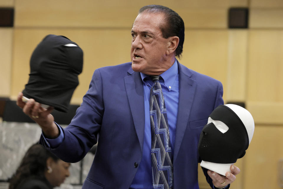 During his closing argument, Trayvon Newsome's attorney George Edward Reres looks back at his client as he vehemently argues that neither of the masks he's holding were worn by his client, during the XXXTentacion murder trial at the Broward County Courthouse in Fort Lauderdale, Fla., Tuesday, March 7, 2023. Emerging rapper XXXTentacion, born Jahseh Onfroy, 20, was killed during a robbery outside of Riva Motorsports in Pompano Beach in 2018, allegedly by defendants Michael Boatwright, Newsome, and Dedrick Williams. (Amy Beth Bennett/South Florida Sun-Sentinel via AP, Pool)