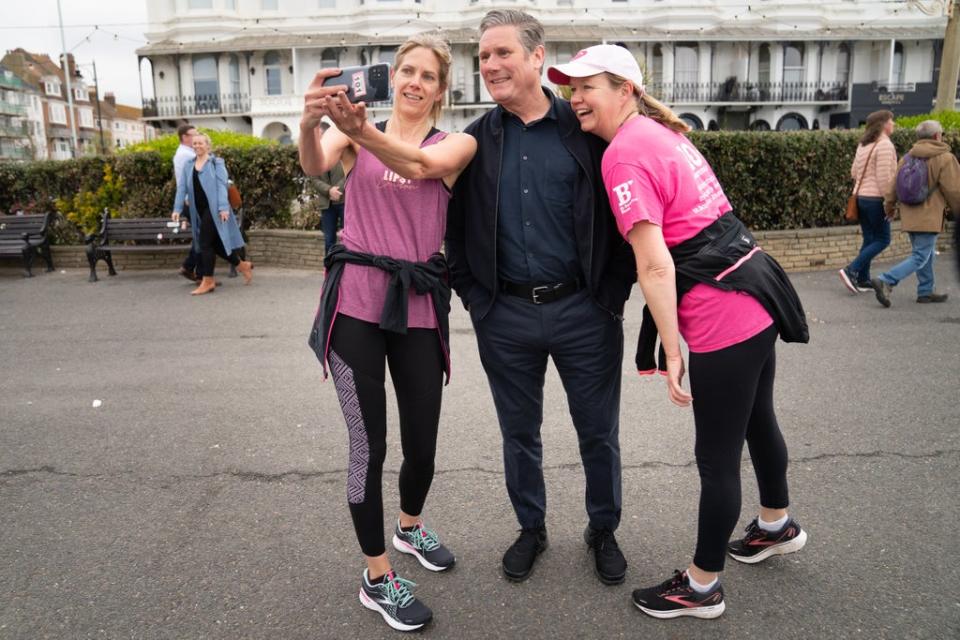 Labour Leader Sir Keir Starmer meets two runners on Worthing sea front in West Sussex while out campaigning (Stefan Rousseau/PA) (PA Wire)