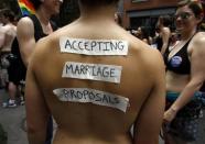 A woman wears a sign on her back which reads, 'Accepting Marriage Proposals' during the Gay Pride Parade in New York June 26, 2011.