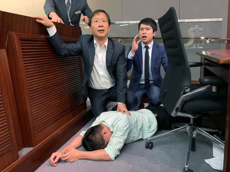 Pro-democracy lawmaker Gary Fan lies down after clashs with pro-Beijing lawmakers during a meeting for control of a meeting room to consider the controversial extradition bill, in Hong Kong, China May 11, 2019. REUTERS/James Pomfret