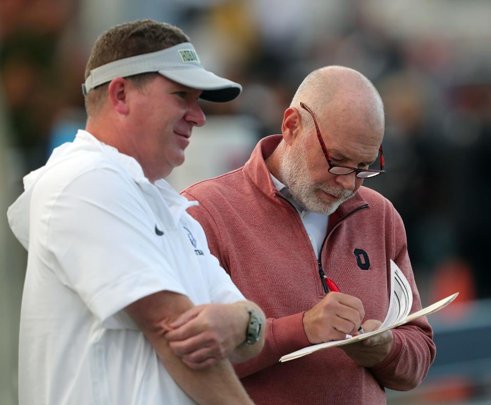 Ohio State defensive coordinator Jim Knowles, right, was in attendance for the Hoban's game against Walsh Jesuit on Sept. 29 in Akron.