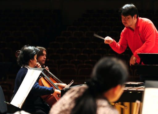 Russian cellist Oleg Vedernikov (2nd L) rehearses with the Beijing Symphony Orchestra in Beijing in March. The orchestra has fired Vedernikov after he was caught on camera verbally abusing a female passenger on a train