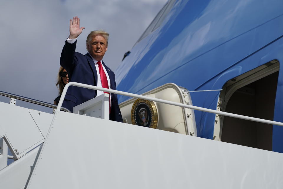 President Donald Trump waves as he and first lady Melania Trump board Air Force One to travel to Nashville, Tenn., for the presidential debate, Thursday, Oct. 22, 2020, in Andrews Air Force Base, Md. (AP Photo/Evan Vucci)