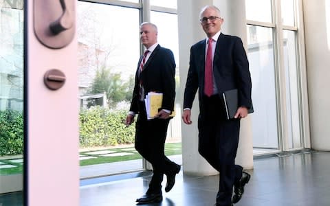 Australian Prime Minister Malcolm Turnbull, right, and Deputy Prime Minister Michael McCormack leave after a party room meeting at Parliament House in Canberra - Credit: AP