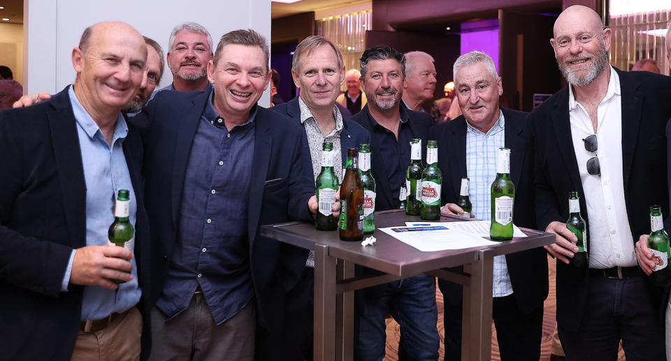 Adam (second from left) enjoys a beer with friends.