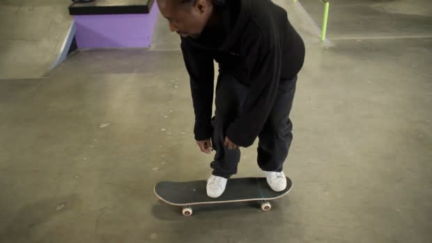 Your front foot in the middle of the skateboard just below the bolts and your back foot on the tail.