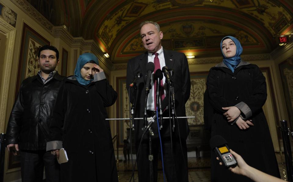 Sen. Tim Kaine, D-Va., chairman of the Senate Foreign Relations Subcommittee on Near Eastern, Southern and Central Asian Affairs, speaks during a news conference on Capitol Hill in Washington, Thursday, Feb. 6, 2014, with Heba Sawan, second from left, and her sister Amineh Sawan, right, and Anas al-Dabas, left. The Sawan sisters were survivors of the August 2013 chemical weapons attack in Moadamiya, Syria that left more than 1,200 Syrians dead and many more wounded. Al-Dabas witnessed the 2012 massacre in Daraya that took the lives of 540 Syrians. (AP Photo/Susan Walsh)