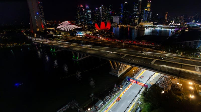 Carlos Sainz of Spain driving (55) the Ferrari SF-23 leads Charles Leclerc of Monaco driving the (16) Ferrari SF-23 during the F1 Grand Prix of Singapore at Marina Bay Street Circuit on September 17, 2023 in Singapore, Singapore