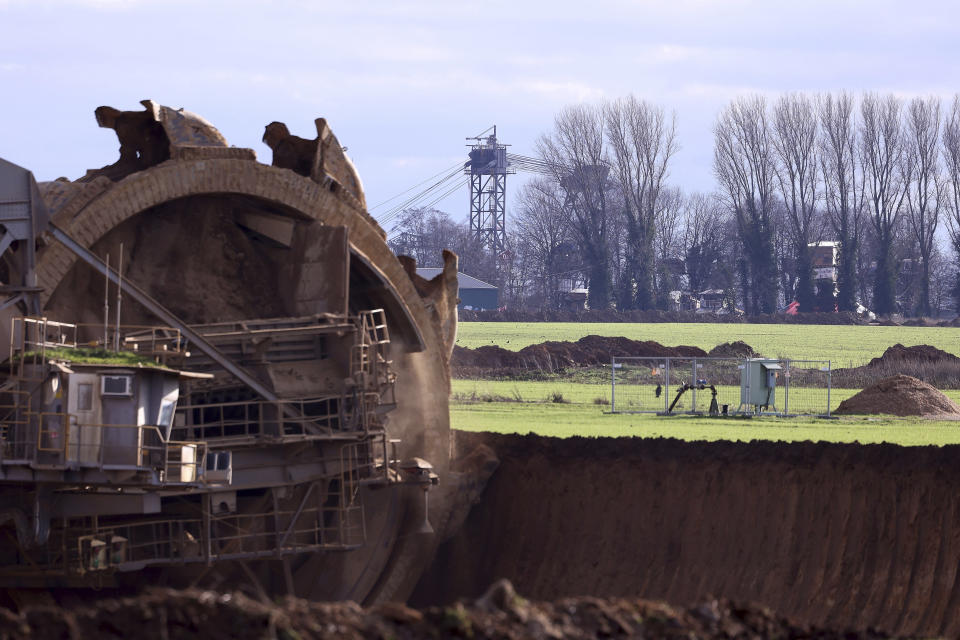 A bucket-wheel excavator removes the soil near the lignite village Luetzerath district ahead of the expected clearance of the lignite village of Luetzerath, Erkelenz, Germany, Saturday, Jan.7, 2023. (David Young/dpa via AP)