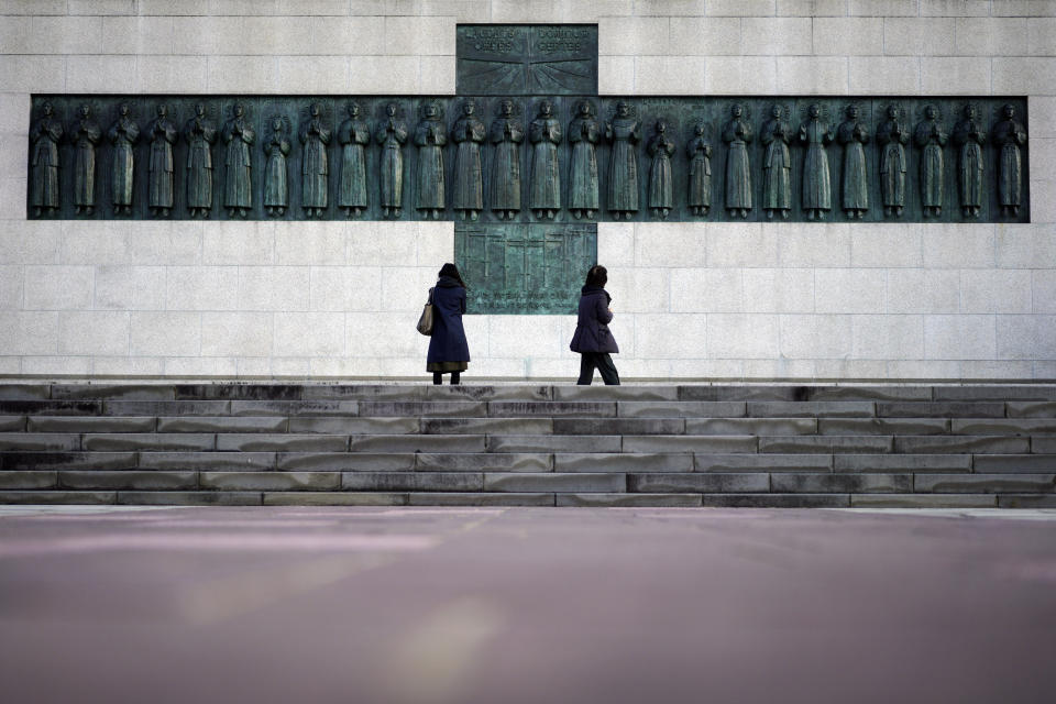 In this Nov. 17, 2019, photo, people visit the Twenty-Six Martyrs Monument in Nagasaki, southern Japan. Pope Francis will start his first official visit to Japan in Nagasaki, ground zero for the Christian experience in a nation where the Catholic leader once dreamed of living as a missionary. (AP Photo/Eugene Hoshiko)