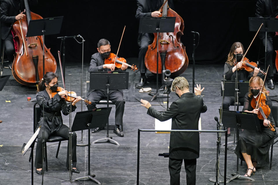 CORRECTS SPELLING OF FIRST NAME TO ESA INSTEAD OF ESSA - Esa-Pekka Salonen, music director of the San Francisco Symphony and principal conductor of London's Philharmonia Orchestra, leads members of the New York Philharmonic as a guest conductor before an audience of 150 concertgoers at The Shed in Hudson Yards, Wednesday, April 14, 2021, in New York. It was the first time since March 10, 2020, that the entire orchestra performed together in front of a live audience. (AP Photo/Kathy Willens)