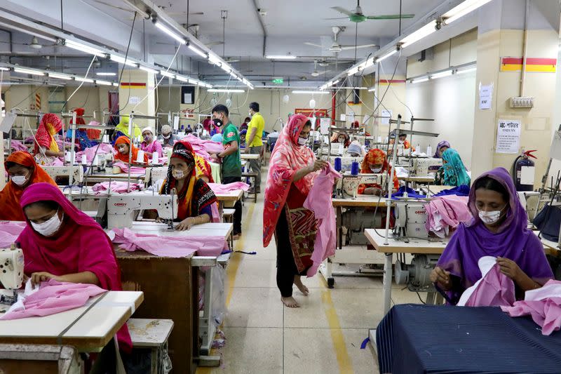 FILE PHOTO: Women work in a garment factory, as factories reopened after the government has eased the restrictions amid concerns over coronavirus disease (COVID-19) outbreak in Dhaka