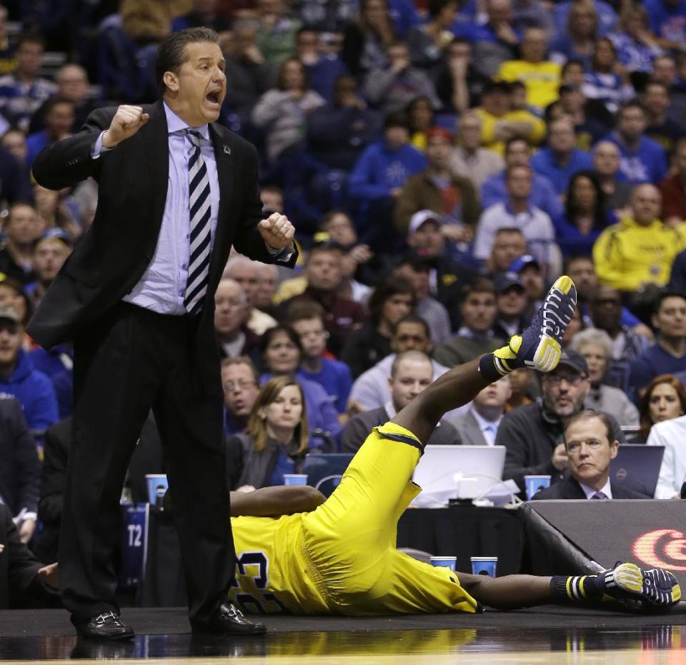 Kentucky head coach John Calipari yells as Michigan's Caris LeVert dives out of bounds during the second half of an NCAA Midwest Regional final college basketball tournament game Sunday, March 30, 2014, in Indianapolis. (AP Photo/David J. Phillip)