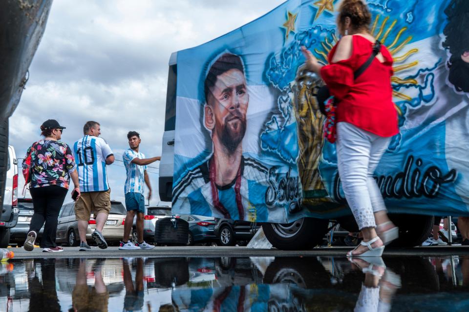 Fans walk by an image of Inter Miami's Lionel Messi as they arrive to attend an MLS soccer match against the New York Red Bulls at Red Bull Arena, Saturday, Aug. 26, 2023, in Harrison, N.J. (AP Photo/Eduardo Munoz Alvarez)