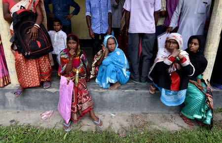 REFILE - UPDATING BYLINE Villagers wait outside the National Register of Citizens (NRC) centre to get their documents verified by government officials, at Mayong Village in Morigaon district, in the northeastern state of Assam, India July 8, 2018. Picture taken July 8, 2018. REUTERS/Stringer