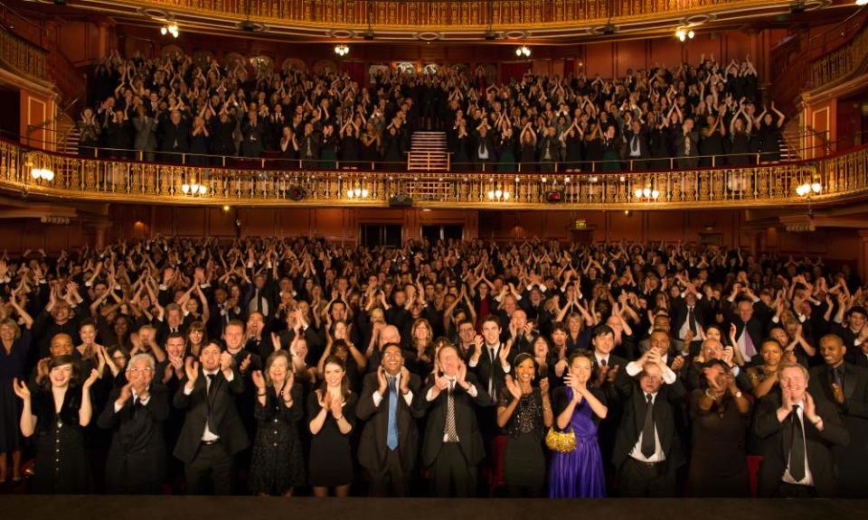 An audience giving a standing ovation