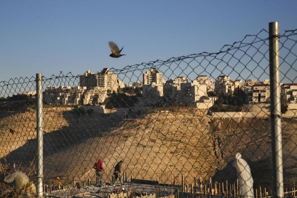 FILE -- In this Tuesday, Feb. 7, 2017 file photo, Palestinian laborers work at a construction site in a new housing project in the Israeli settlement of Maale Adumim, near Jerusalem. The Trump administration appears to be easing away from longstanding U.S. support for Palestinian statehood as the preferred outcome of Middle East peace efforts, which may please some allies of Prime Minister Benjamin Netanyahu in Israel. But the alternatives are few, and each comes with daunting and combustible complications, including for Israel itself. (AP Photo/Oded Balilty, File)