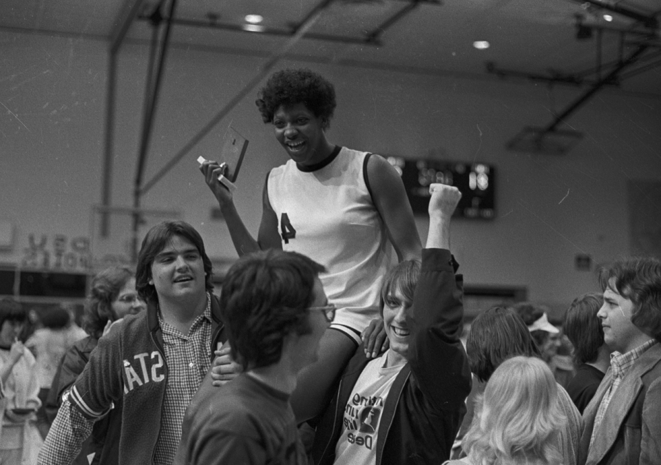 Lusia Harris is hoisted on the shoulders of fans at Delta State, where she led her team to three national titles.