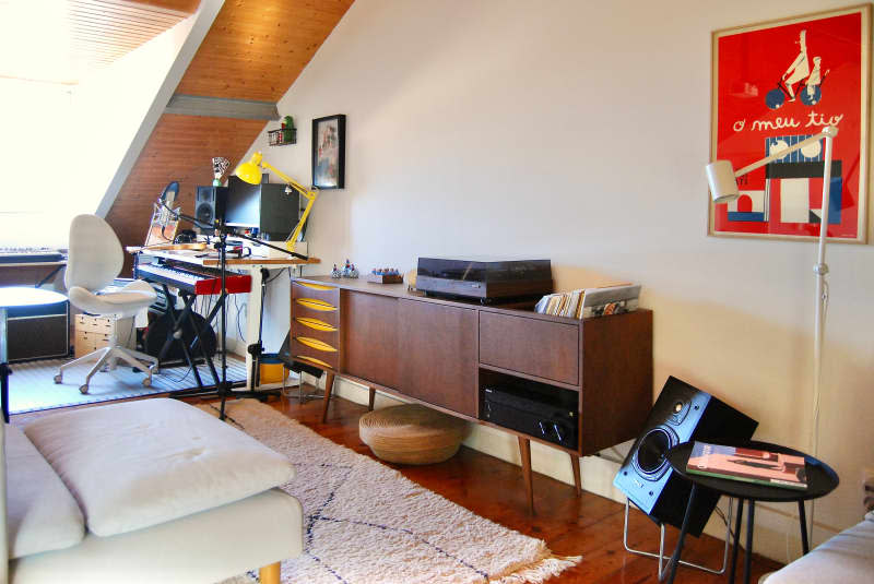 Record player and keyboards in white music room.