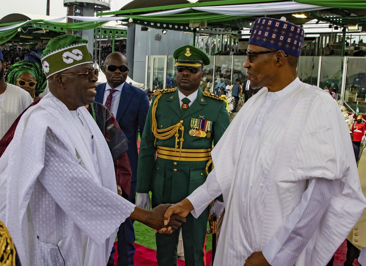 In this photo released by the Nigeria State House, Nigeria’s new President Bola Ahmed Tinubu, left, greets former Nigerian President Muhammadu Buhari during the inauguration ceremony in Abuja, Nigeria, Monday May 29, 2023. (Sunday Aghaeze/Nigeria State House via AP)