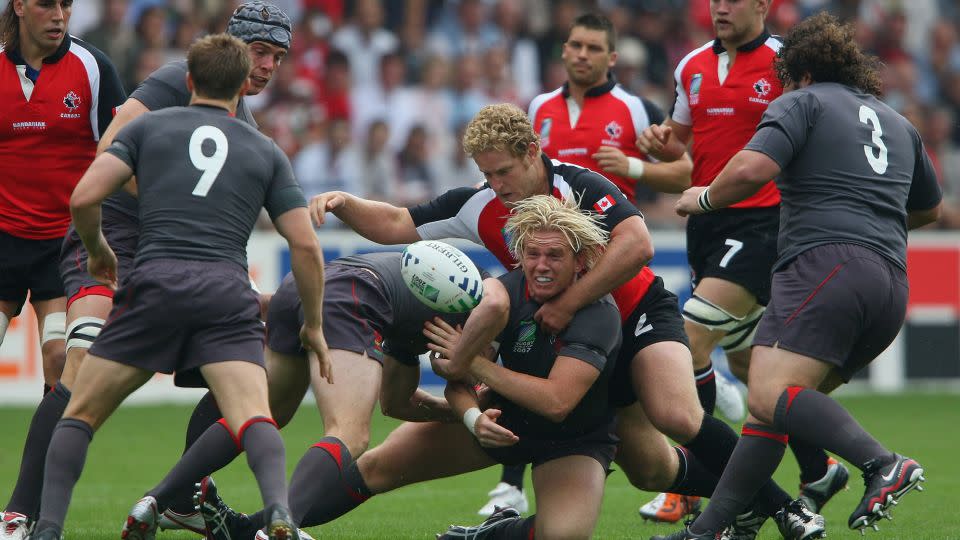 Alix Popham of Wales offloads as he is wrapped up by Pat Riordan of Canada during the Rugby World Cup 2007 Pool B match between Wales and Canada in Nantes, France. - Stu Forster/Getty Images Europe/Getty Images