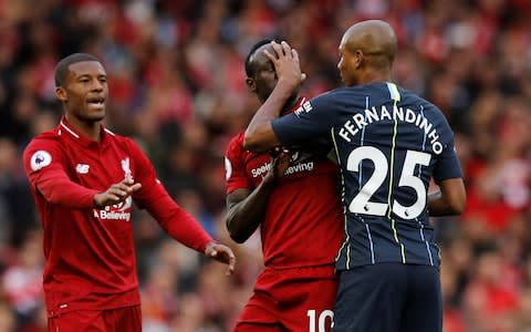 Liverpool's Sadio Mane clashes with Manchester City's Fernandinho - Credit: Reuters