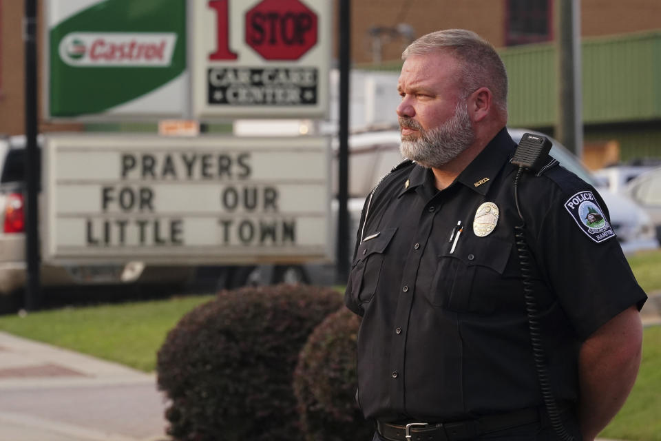 A police watches a vigil for the victims of Saturday's mass shooting on Monday, July 17, 2023, in Hampton, Ga. (AP Photo/John Bazemore)