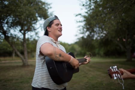 Layton Guenther gathers with other farmers for a potluck dinner and music in Amagansett