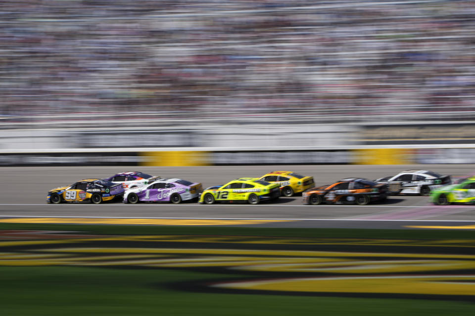 Daniel Suarez (99) leads the race at a restart during a NASCAR Cup Series auto race Sunday, Oct. 16, 2022, in Las Vegas. (AP Photo/John Locher)