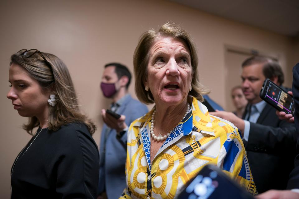 Sen. Shelley Moore Capito, R-W.Va., the GOP's lead negotiator on a counteroffer to President Joe Biden's infrastructure plan, walks with reporters as senators go to the chamber for votes on Thursday.