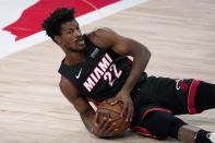 Miami Heat forward Jimmy Butler recovers a loose ball on the floor during the first half of Game 4 of the team's NBA basketball Eastern Conference final against the Boston Celtics on Wednesday, Sept. 23, 2020, in Lake Buena Vista, Fla. (AP Photo/Mark J. Terrill)
