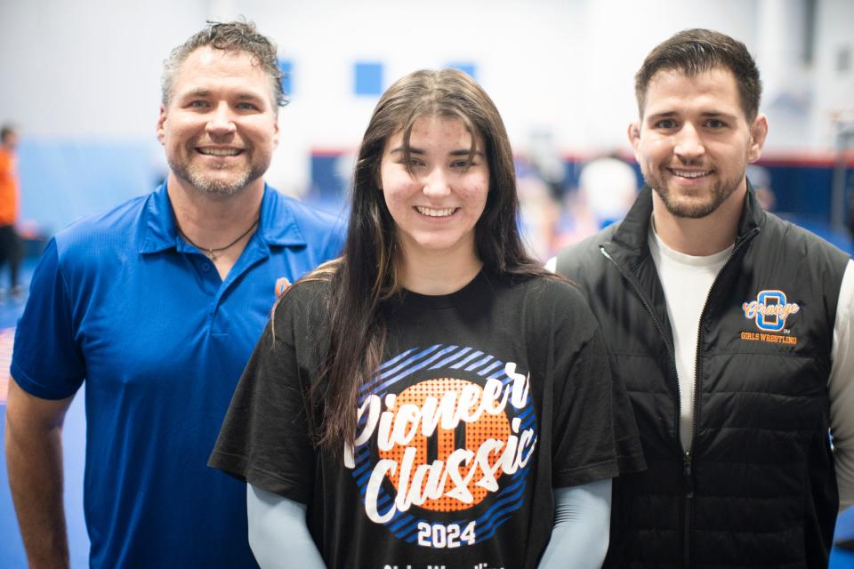 Olentangy Orange senior wrestler Kascidy Garren competes for a coaching staff that includes her brother, Patrik, right, and father Jack. Patrik won a state championship for Ready.