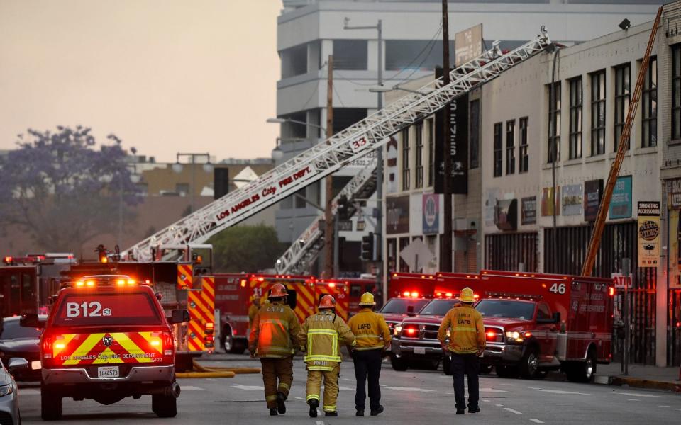 Los Angeles Fire Department firefighters work the scene of a structure fire - AP Photo/Mark J. Terrill
