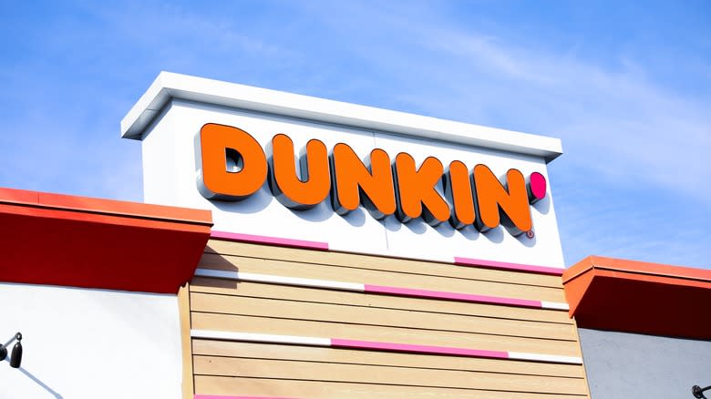 Dunkin' storefront with a blue sky