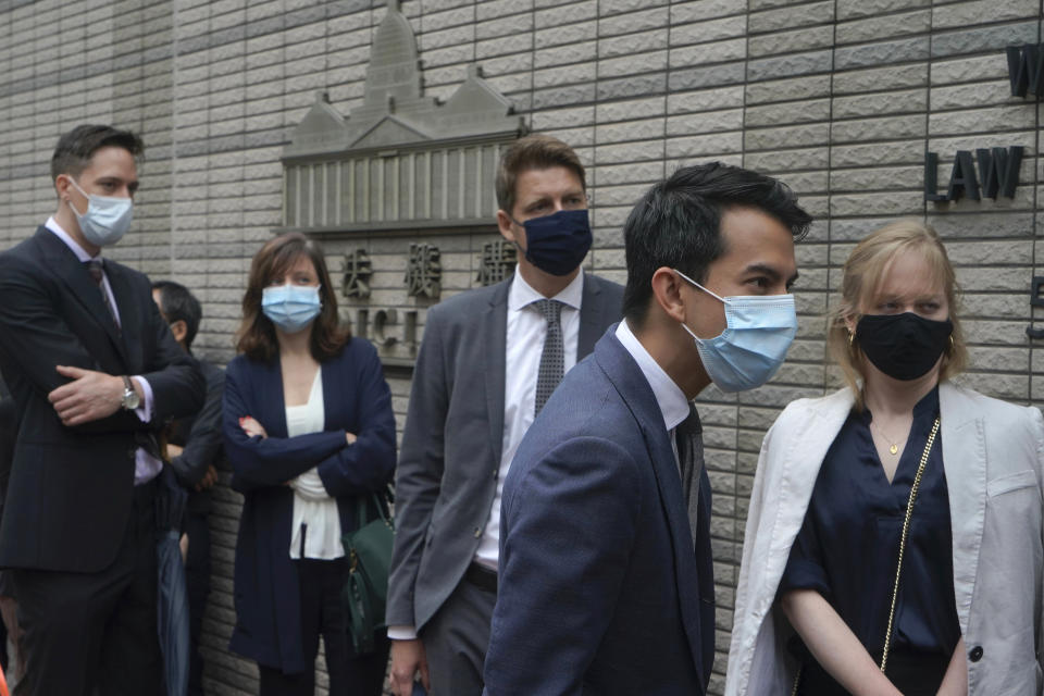 Diplomatic representatives from left, the Netherlands, France, Sweden, Australia and Canada wait to enter a court in Hong Kong Friday, April 16, 2021. Seven of Hong Kong’s leading pro-democracy advocates, including 82-year-old veteran activist Martin Lee and pro-democracy media tycoon Jimmy Lai, are expected to be sentenced Friday for organizing a march during the 2019 anti-government protests that triggered an overwhelming crackdown from Beijing.(AP Photo/Kin Cheung)