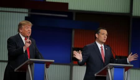 Republican U.S. presidential candidates businessman Donald Trump (L) and Senator Ted Cruz speak simultaneously at the Fox Business Network Republican presidential candidates debate in North Charleston, South Carolina, January 14, 2016. REUTERS/Chris Keane