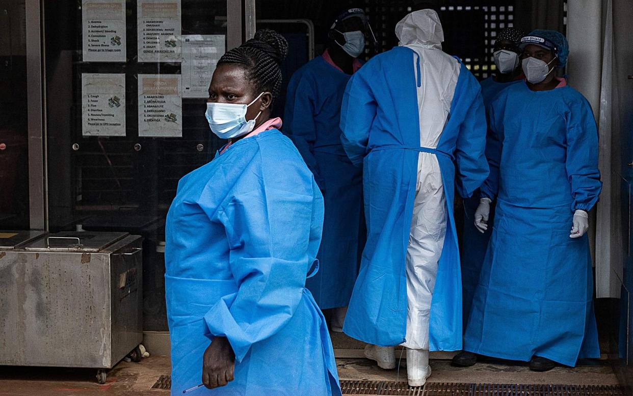 Members of the Ugandan Medical staff of the Ebola Treatment Unit stand inside the ward in Personal Protective Equipment (PPE) at Mubende Regional Referral Hospital in Uganda on September 24, 2022