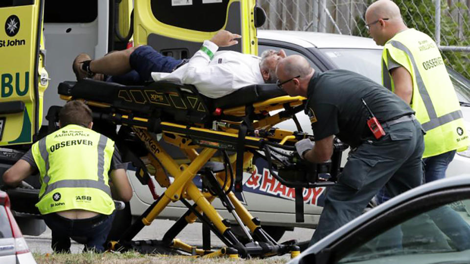 Emergency services personnel assist one of the victims. Image: AP