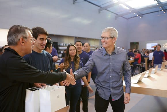 Apple CEO Tim Cook shakes hands with fans at an Apple store the day of the iPhone 8 launch