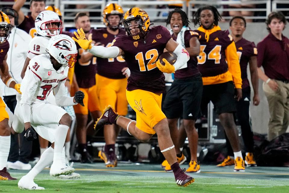 Arizona State tight end Jalin Conyers (12) runs with the ball as Southern Utah cornerback Lacarea Pleasant-Johnson (31) and safety Trevon Gola-Callard (12) defend during the first half of an NCAA college football game Thursday, Aug. 31, 2023, in Tempe, Ariz. (AP Photo/Ross D. Franklin)