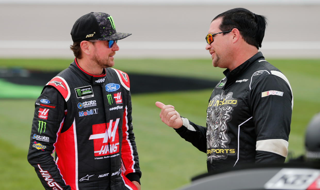 B,J. McLeod (R) talks to 2004 Cup Series champion Kurt Busch. McLeod owns two cars in NASCAR’s No. 2 series. (Getty Images)