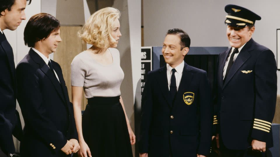 Kevin Nealon, Dana Carvey, Sharon Stone, Rob Schneider and Phil Hartman during "Airport Security Check" skit on April 11, 1992. - Alan Singer/NBC/Getty Images
