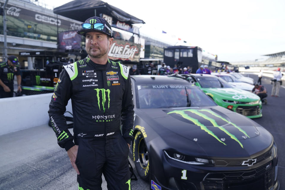 FILE - Kurt Busch walks in the pits before qualifications for the NASCAR Series auto race at Indianapolis Motor Speedway, Sunday, Aug. 15, 2021, in Indianapolis. Busch announced Saturday, Oct. 15, 2022 he will miss the rest of this season with a concussion and will not compete full-time in 2023. The 44-year-old made his announcement at Las Vegas Motor Speedway, his home track and where he launched his career on the bullring as a child. He choked up when he said doctors told him “it is best for me to ‘shut it down.'” (AP Photo/Darron Cummings, File)