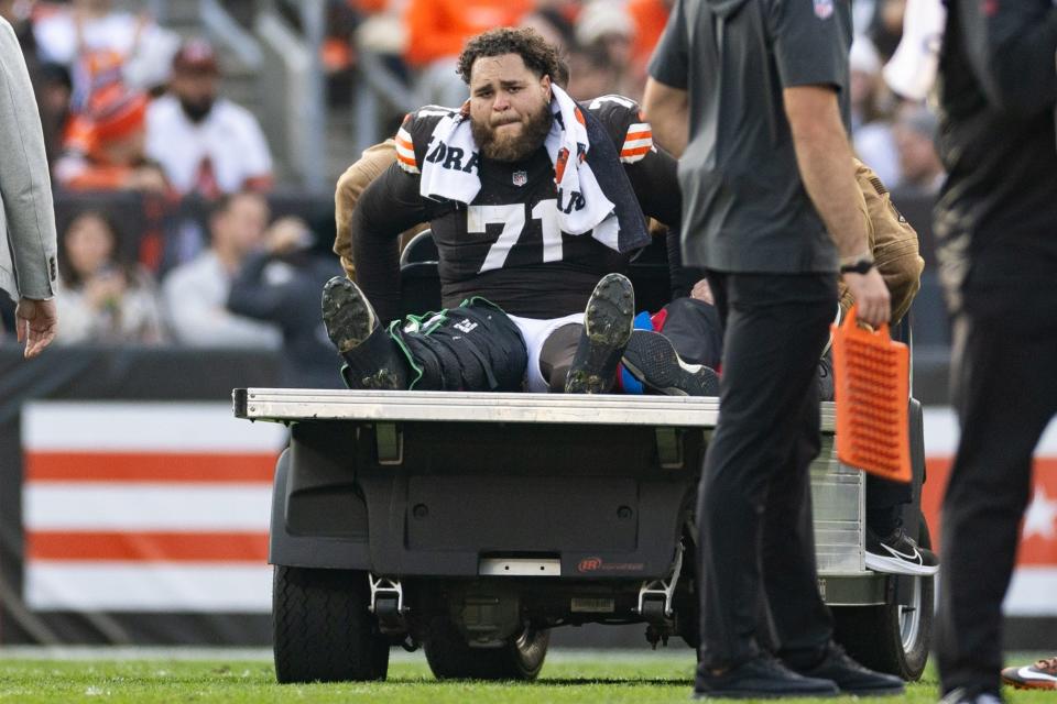 Cleveland Browns offensive tackle Jedrick Wills Jr. (71) cries as he is carted off the field after an injury during the third quarter Sunday against the Arizona Cardinals in Cleveland.