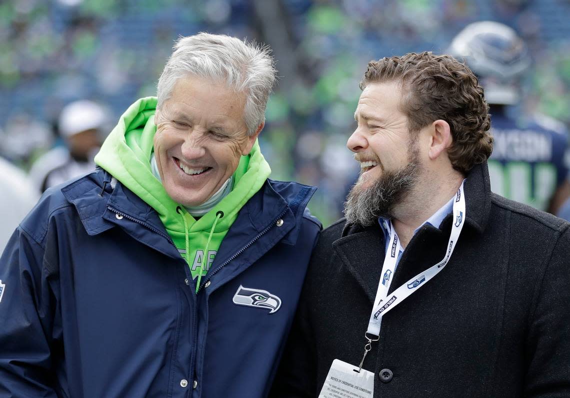 Seattle Seahawks head coach Pete Carroll, left, talks with general manager John Schneider before the first half of an NFL football game against the Arizona Cardinals, Sunday, Dec. 30, 2018, in Seattle. (AP Photo/Ted S. Warren)