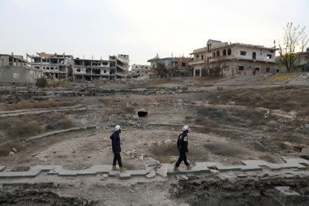 FILE PHOTO - Members of the Civil Defence, also known as the 'White Helmets', are seen inspecting the damage at a Roman ruin site in Daraa, Syria December 23, 2017. REUTERS/Alaa al-Faqir