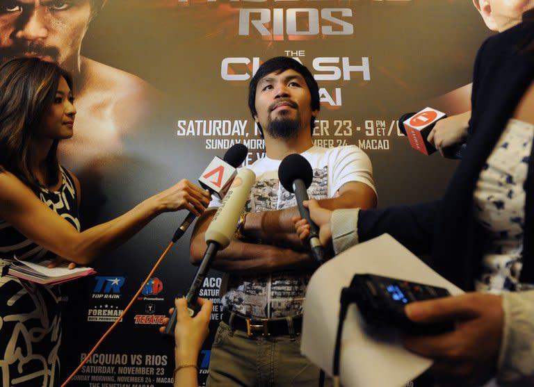 Manny Pacquiao speaks to the media at Marina Bay Sands in Singapore on Friday. The Philippine boxing icon says he can fight for another three years despite two successive losses, brushing aside calls for him to retire and focus on his political career