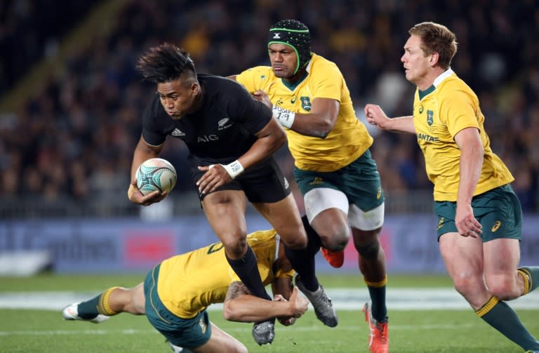 New Zealand's Julian Savea is tackled by Australia's Henry Speight (2nd R), Bernard Foley (R) and Israel Folau during the third Bledisloe Cup Test at Eden Park in Auckland on October 22, 2016