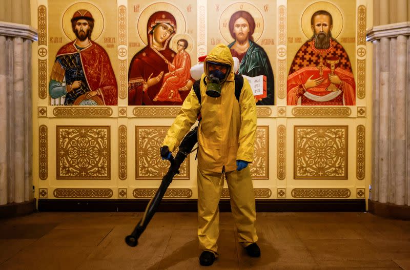 FILE PHOTO: A specialist sanitizes a railway station amid the outbreak of the coronavirus disease in Moscow