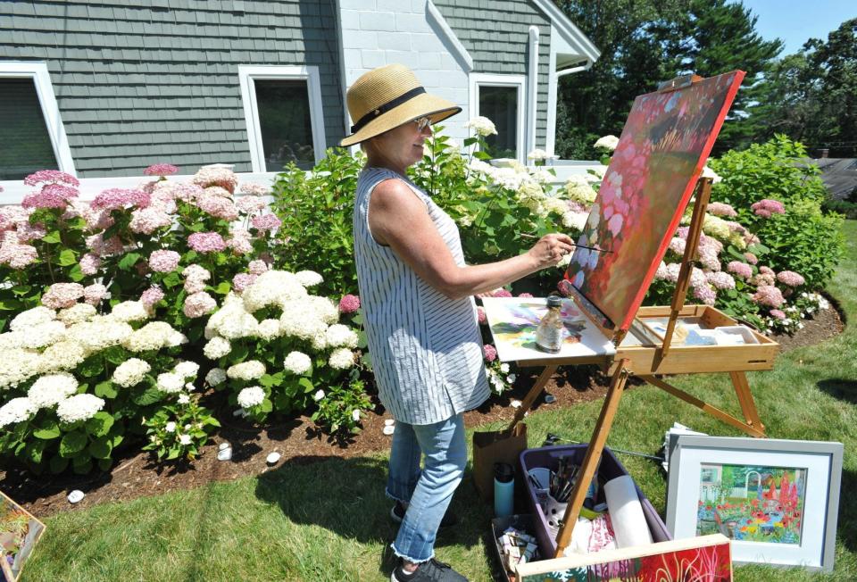 Artist Suzette Macdonald Lebenzon, of Wellfleet, creates paintings of hydrangeas at the Duxbury home of Andrea and David Brandeis during the hydrangea garden tour hosted by the Community Garden Club of Duxbury, Tuesday, July 12, 2022.